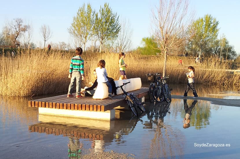 Familias enteras ocupaban los bancos en la zona inundada accediendo por pequeños caminos.